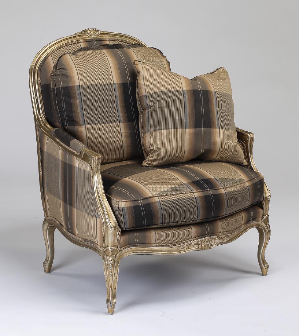 Henredon Louis XV style carved gilt-decorated bergere: Henredon Louis XV style gilt-decorated bergere, having a carved and gilt-decorated crest over the loose back and seat cushions, flanked by padded arms, all over an undulating apron centering a floral 