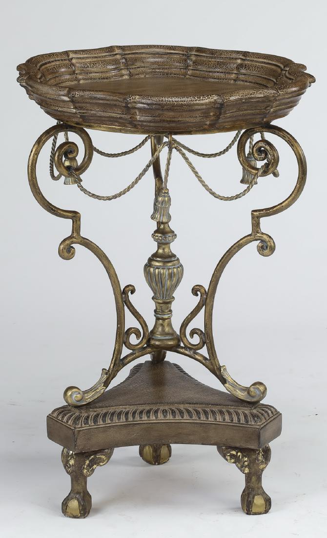 Neoclassical style silvered side table: Neoclassical style side table, executed in silver paint decorated composite materials and iron, having a scalloped circular top with a dished rim, rising on scrolling iron legs hung with faux passemen