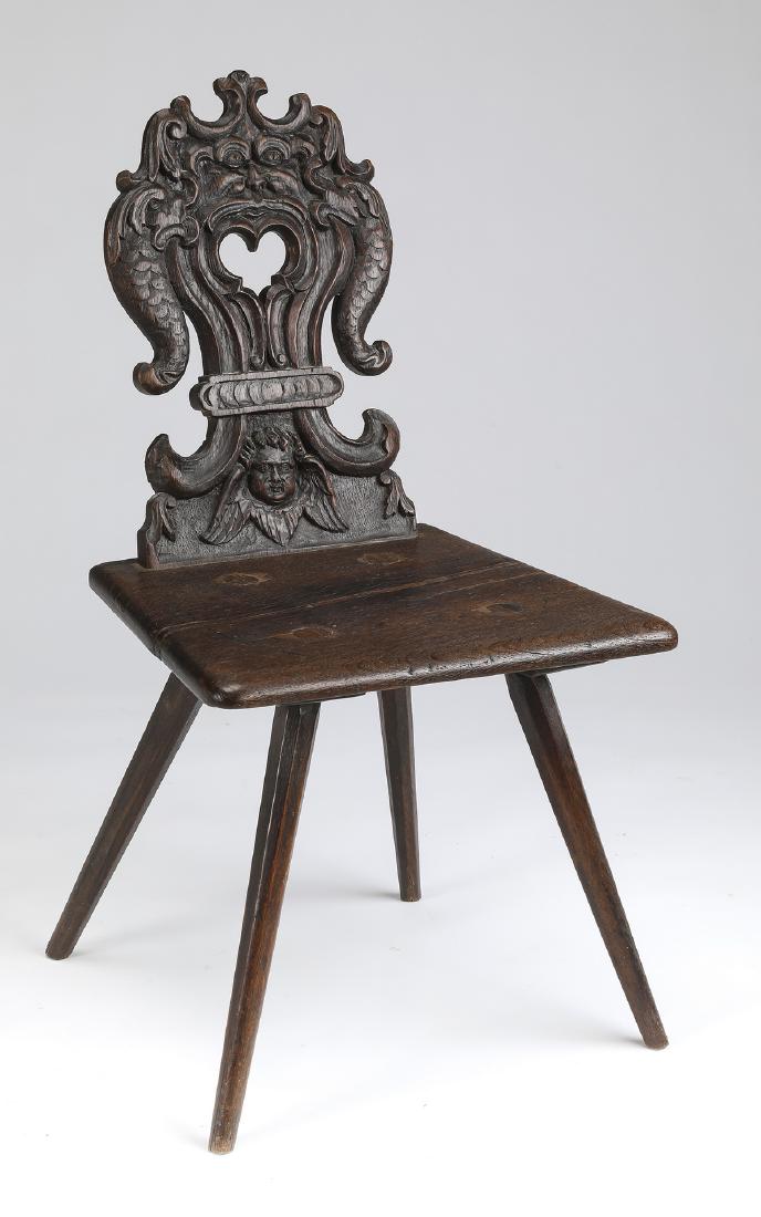 19th c. French carved oak hall chair, 34"h: 19th c. French Renaissance Revival oak hall chair, the back carved as a grotesque mask flanked by dolphins transforming into a tied fleur de lis above an angel, surmounting a plank seat resting on fou