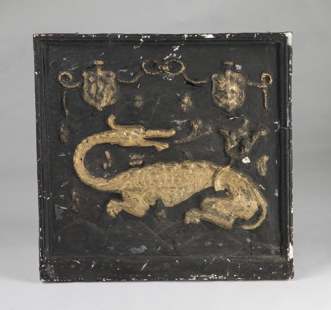 Armorial cast plaster plaque, emblem of Francis I: 19th century armorial cast plaster plaque depicting the emblem of Francis I. having a gilt accented bow and flanking shields, above a gilded recumbant salamander, the whole on a black ground, framed i