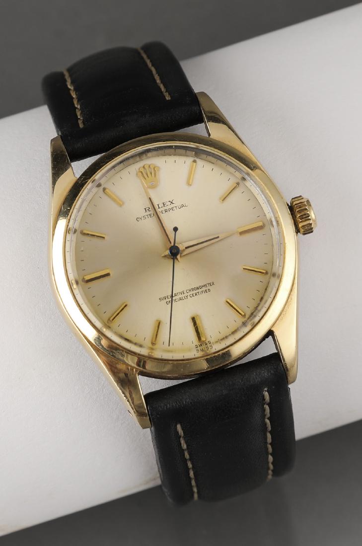 Rolex Oyster Perpetual Model 1014, 34mm case: Rolex Oyster Perpetual Model 1014, having index hour markers, dagger hands, and a smooth bezel, with a leather strap, 34mm case. **Please note that all fine jewelry purchases must be paid for with eit