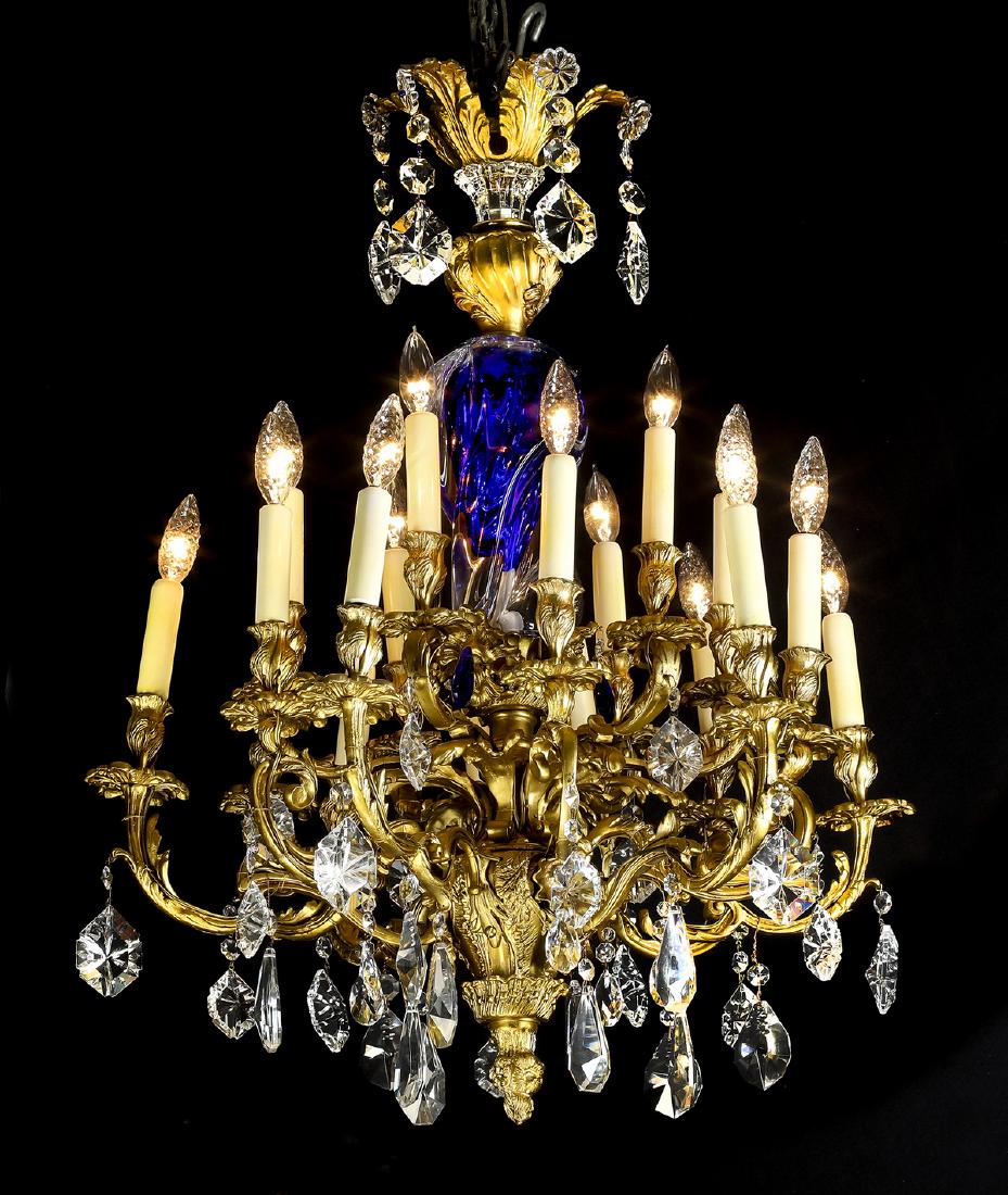 19th c. gilt bronze and crystal 15-light chandelier: Gilt bronze and crystal 15-light chandelier, in the Baroque style, 19th century, having a gilt bronze crown of curving acanthus leaves suspending pendants headed with crystal flowers, surmounting a ga