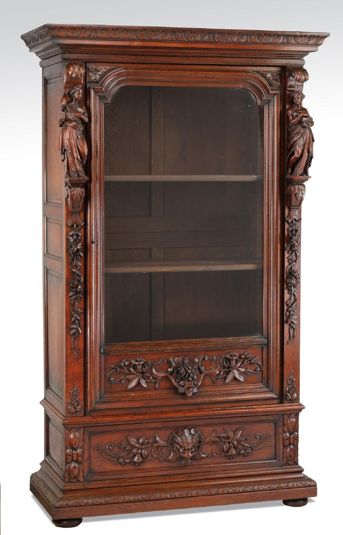 19th c. French walnut cabinet w/ carved maidens: French Renaissance Revival style walnut cabinet, late 19th century, having a carved acanthus motif cornice, above a shaped glass front cabinet door opening to two adjustable shelves, decorated with a 