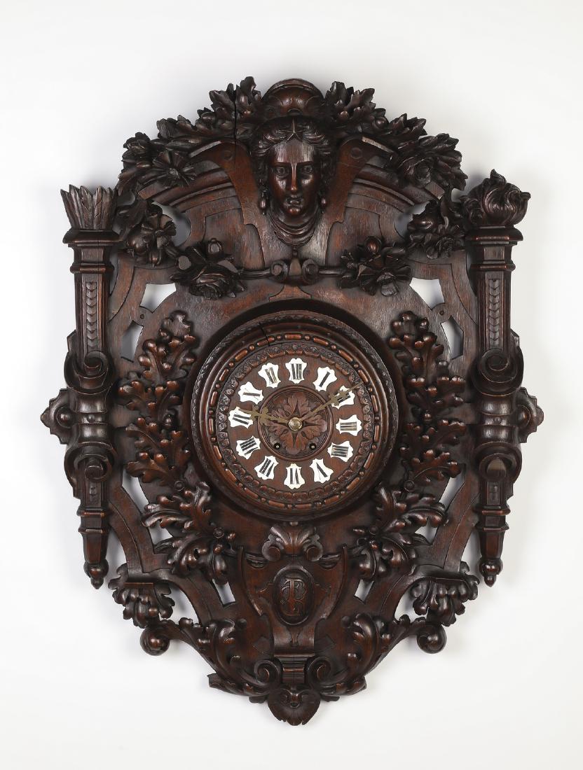 Oversized 19th c. German carved oak wall clock: Oversized German Renaissance Revival oak wall clock, late 19th century, having a carved arching floral crest centering a goddess bust against strapwork, over a carved panel with fruit and floral swags