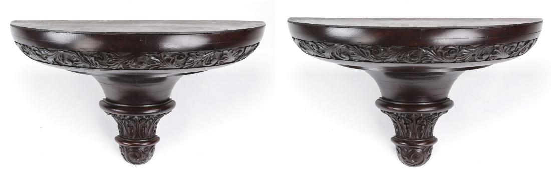 (2) Oversized carved wall brackets, 38"w: Pair of oversized hardwood wall brackets in the Neoclassical taste, the demi-lune shaped brackets with relief-carved acanthus bands, each 25"h x 38"w x 18.25"d.