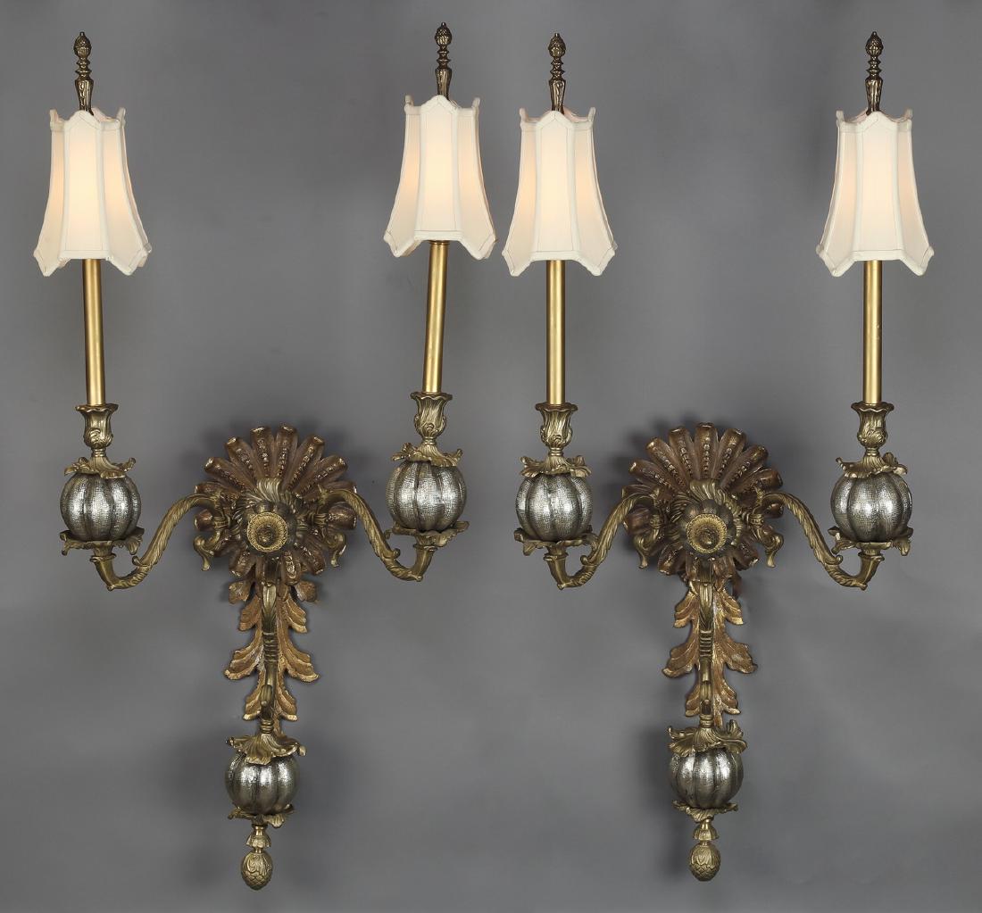 (2) Gilded iron foliate form sconces w/ silk shades: Pair of gilded iron foliate form wall sconces, each having a fluted circular mount with a central finial, flanked by foliate form 'S' scroll arms, terminating in reeded spheres supporting lights with 