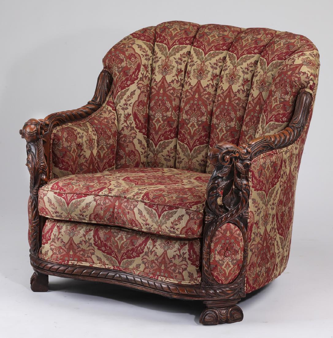 Tub chair upholstered in multicolored jacquard, 33"h: American Renaissance Revival tub chair, upholstered in a multicolored jacquard woven fabric in a medallion motif, having a rounded channel tufted back flanked by turned carved arms, centering a confor