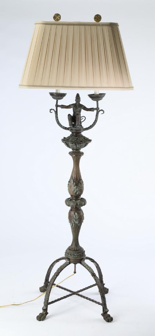 Maitland-Smith bronze figural floor lamp, 56"h: Maitland-Smith patinated bronze figural floor lamp, having two lights covered by a silk pleated shade and Chinoiserie style harp finials, centering a figural monkey support, wearing a shirt, pants, an