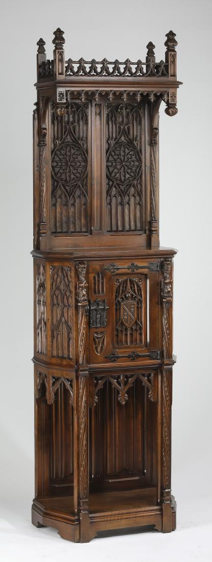 French Gothic Revival cupboard with tracery carvings: French Gothic Revival walnut cupboard, late 19th century, having a rectangular top with carved pierced gallery having carved corner piers topped with finials, over a molded cornice above a carved vala