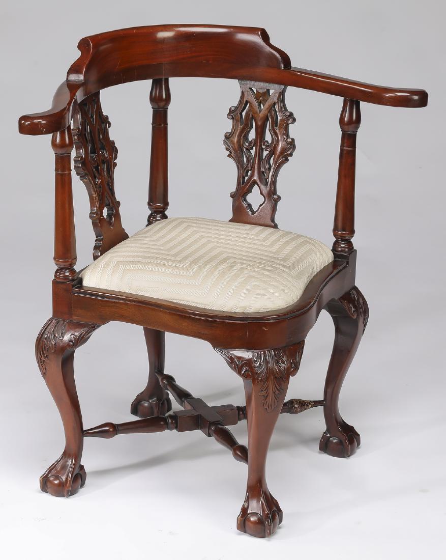 George III style mahogany corner chair: Contemporary George III style mahogany corner chair, the curved crestrail surmounting the pierced backsplats interspaced by turned balusters, leading to the conforming seat upholstered in striped crea