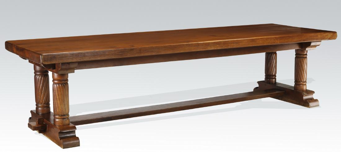 19th c. French Gothic Revival trestle table: Gothic Revival oak trestle table, 19th century, having a solid wood rectangular top, doweled to a frame constructed of two long beams slotted through two cross beams, over four turned supports with di