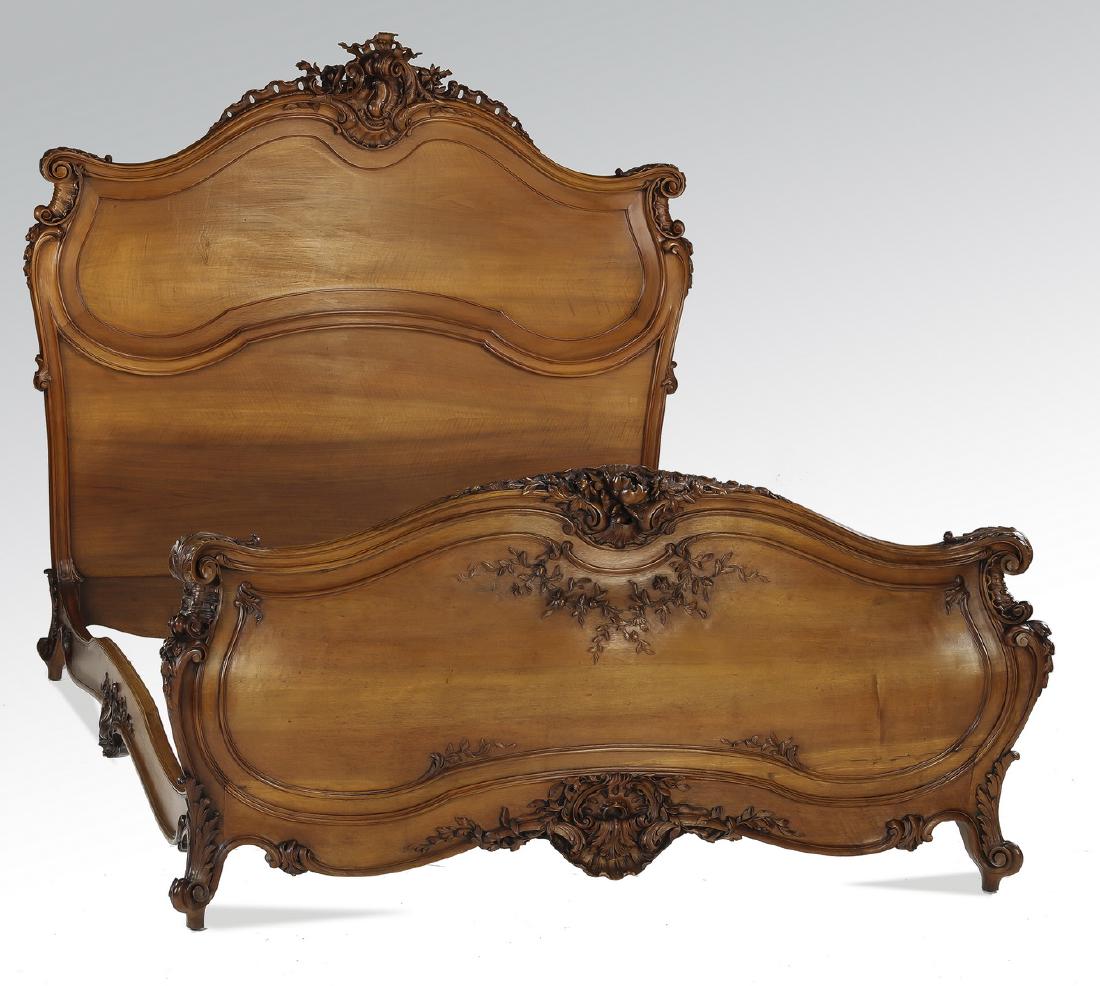 19th c. French Rococo style carved walnut bed: French Rococo Revival carved walnut bed, late 19th century, having a headboard with a highly carved rocaille crest, atop a molded and shaped panel, joined by curving and molded siderails to a footboar