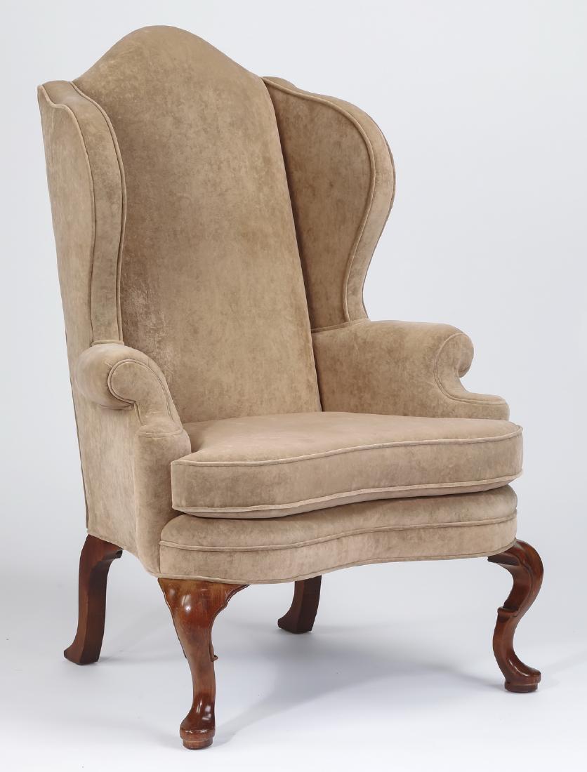 George III style wingback chair w/ velvet upholstery: George III style wingback chair upholstered in velvet, the whole rising on four cabriole legs terminating in padded feet, 49"h x 33"w x 28"d.
