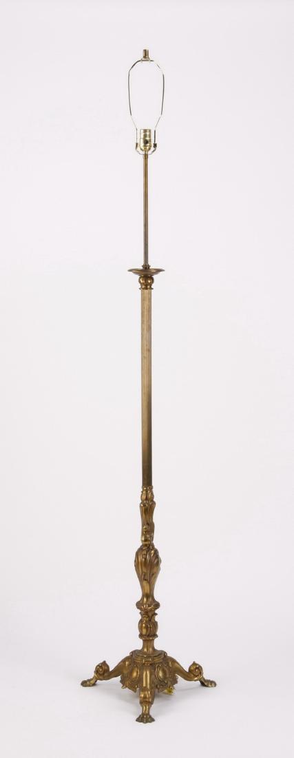 Gilt bronze floor lamp, 72"h: Early 20th century American Rococo inspired gilt bronze floor lamp, the fluted trunk over asymmetrical scrollwork and stylized acanthus leaf designs, the tripod base with alternating scrolling legs an