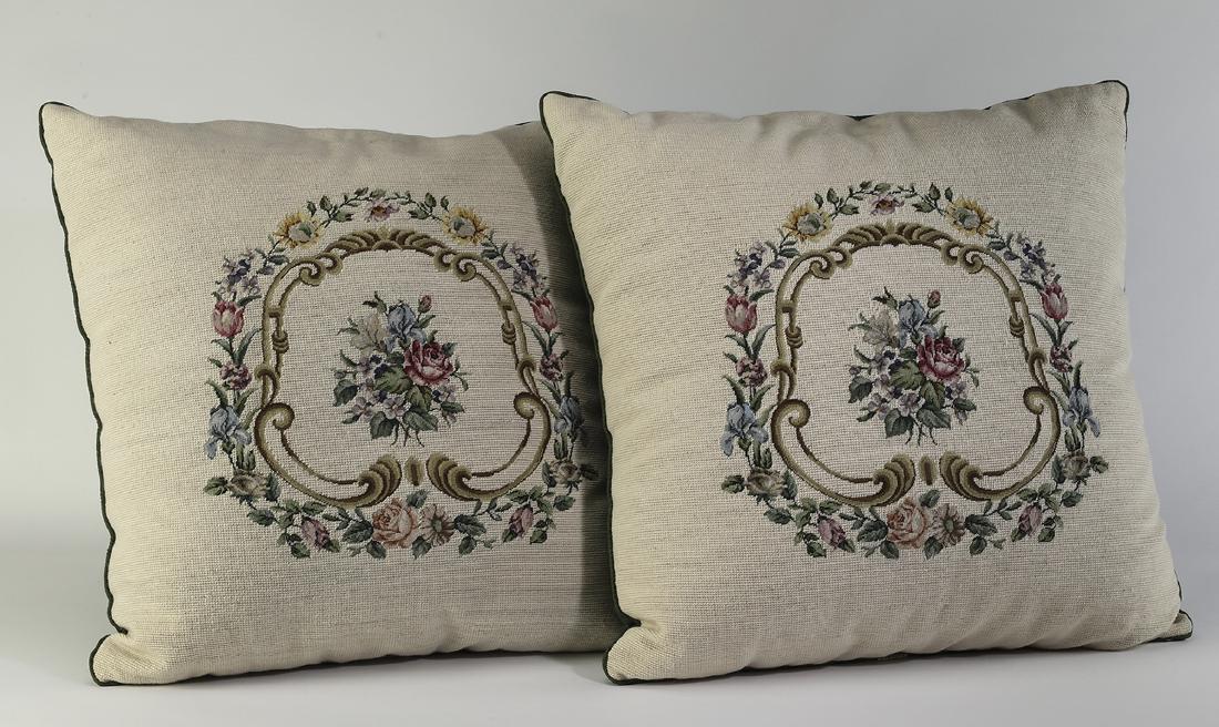 (2) Maitland-Smith wool needlepoint accent pillows: Pair of Maitland-Smith accent pillows, each having wool needlepoint covers decorated with foliates and acanthus scrolls on a neutral cream ground, the backs with green silk, 25"h x 25"w.