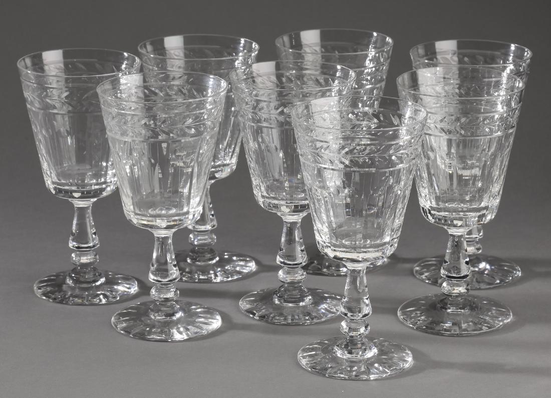 (8) Continental cut crystal wine glasses: Eight Continental cut crystal wine glasses, having a laurel leaf band at the rim and a circular foot, 6.25"h x 3.25"dia.