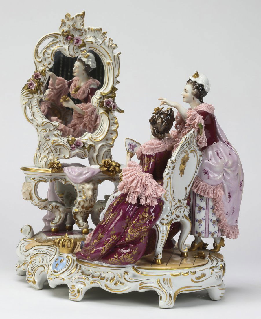 Continental hand painted porcelain figural group: Continental hand painted porcelain figural group, depicting a lady in 18th century garb holding a fan and seated in front of her vanity while being attended to by her maid, modeled in the Meissen styl