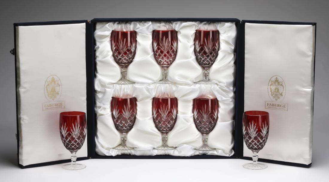 (8) Faberge ruby crystal water goblets w/ fitted case: Set of eight Faberge crystal ruby cut to clear water goblets in the 'Odessa' pattern, maker marked, and having an original fitted case for six glasses, 7"h x 3.30"dia.