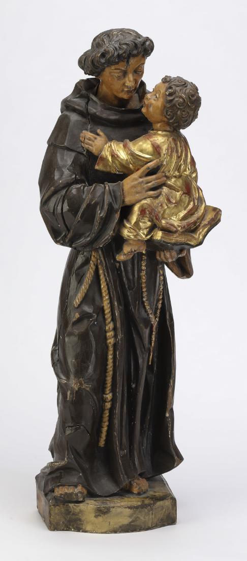 19th c. carved figure of St. Anthony holding Christ: 19th century carved and paint decorated Santos figure, depicting the youthful St. Anthony wearing his brown Franciscan habit and rosary beads, and holding the Christ child, 25.5"h x 10"w x 6"d