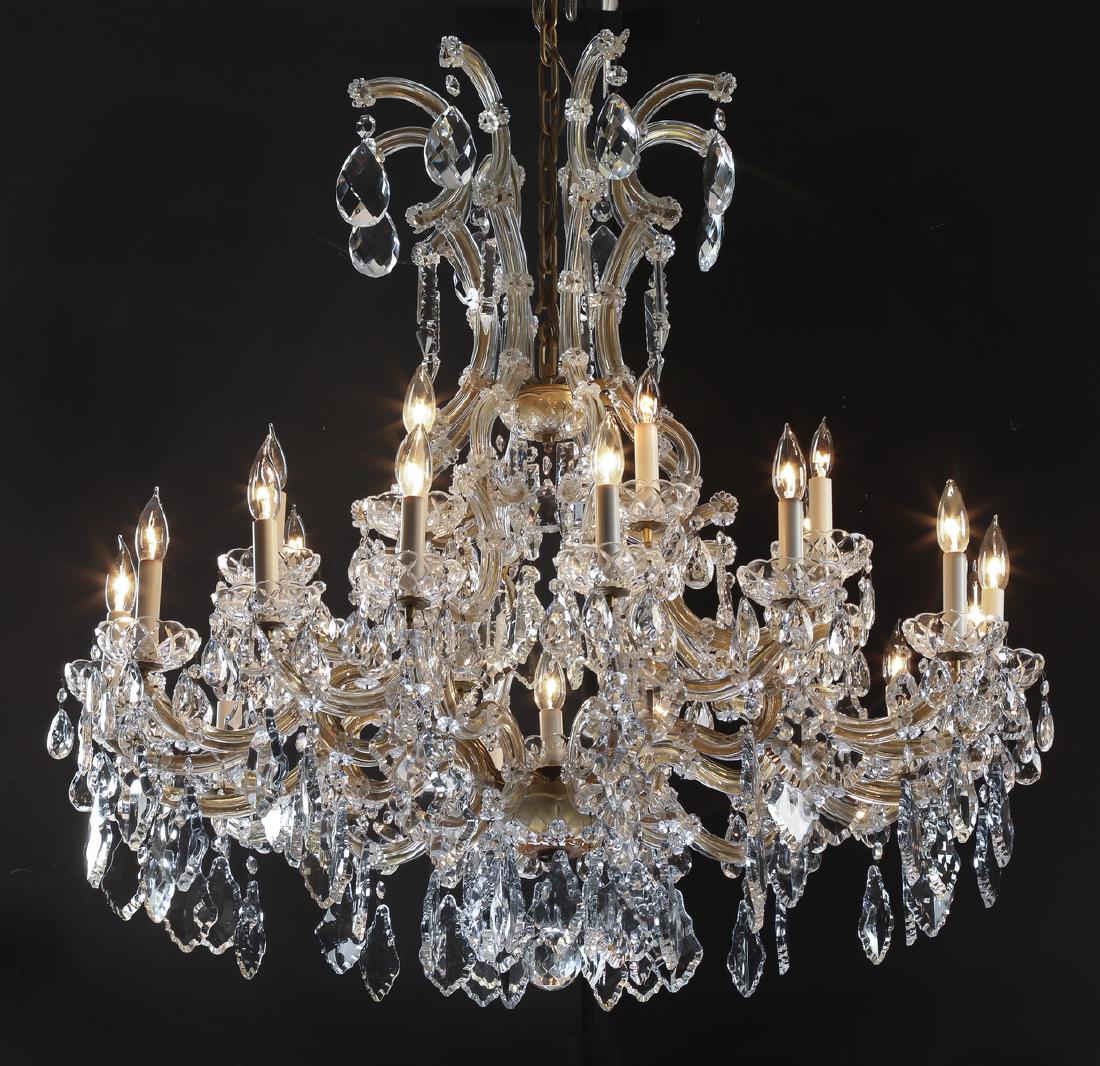 Continental Maria Theresa style 25-light chandelier: Continental Maria Theresa style 25-light chandelier, having foliate form crystals and crystal pendants hanging from the baluster form cage, above an upper tier of 12 'U' form arms ending in scalloped 