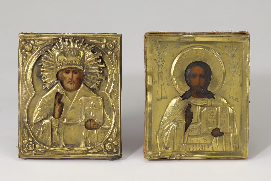 (2) Orthodox icons, St. Nicholas & Christ Pantocrator: Two Orthodox icons, 19th century, executed in oil on canvas laid on board, depicting St. Nicholas and Christ Pantocrator, each under a gilt metal oklad, (1) 5.25"h x 4.25"w x .75"d, (1) 5.25"h x 4.5"w