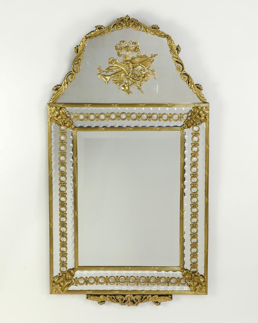 Gilt bronze mounted beveled glass mirror, 60"h: Gilt bronze mounted beveled and wheel cut glass mirror, the scrolling arched top with acanthus leaf border centering a musical instrument medallion, above a rectangular glass bordered with gilt and wh