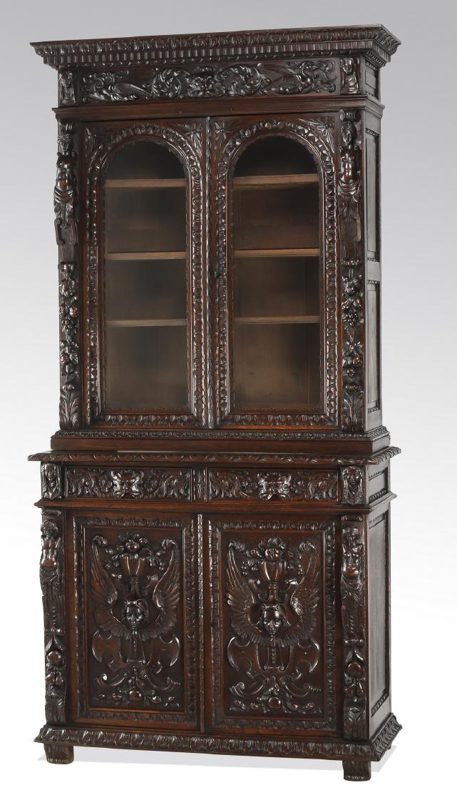 19th c. French carved walnut bookcase: French Renaissance Revival walnut bookcase, late 19th century, having a rectangular top with carved cornice and dentil molding above a relief carved frieze centering a lion's mask with trailing foliag