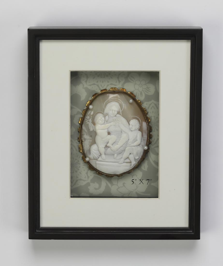 19th c. cameo w/ Madonna, Christ and John the Baptist: Continental conch shell cameo, 19th century, depicting a seated Madonna and Christ child holding a spray of lilies, with John the Baptist to the side, set into a gilt metal fillet and mounted to a boa