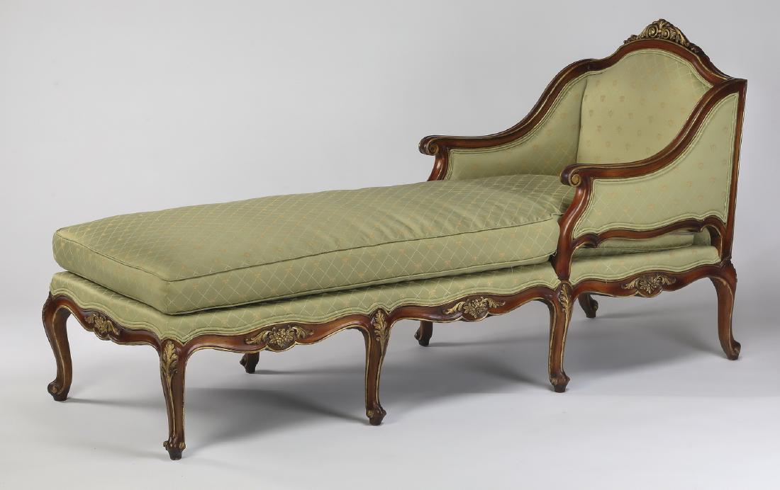 Louis XV style mahogany chaise longue: Louis XV style mahogany chaise longue, having an arched scrolling crest with gilt accents, flowing into integral arms ending in scrolled terminals, flanking a long single cushion, upholstered in celad
