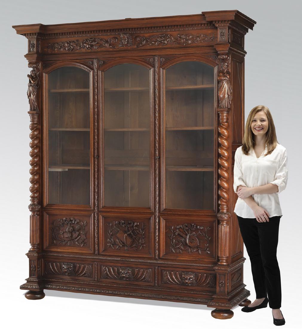 19th c. French Renaissance Revival oak bookcase: French Renaissance Revival oak library bookcase, late 19th century, having a straight breakfront pediment comprised of a classical molded cornice over a relief carved frieze centering a scholar's bust