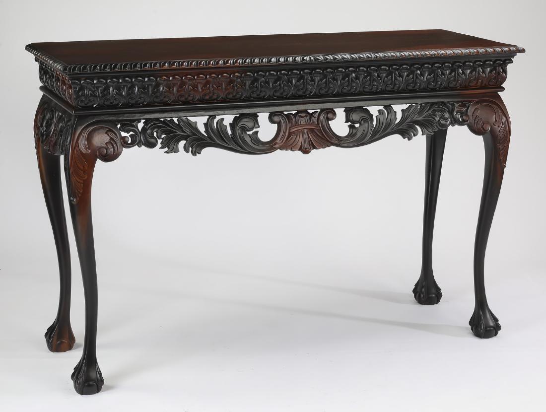 Carved mahogany console table, 60"w: American Renaissance Revival style partially ebonized mahogany console table, having a rectangular top with a gadrooned rim, above a wide apron with a scrolling acanthus motif above a pierced carved a