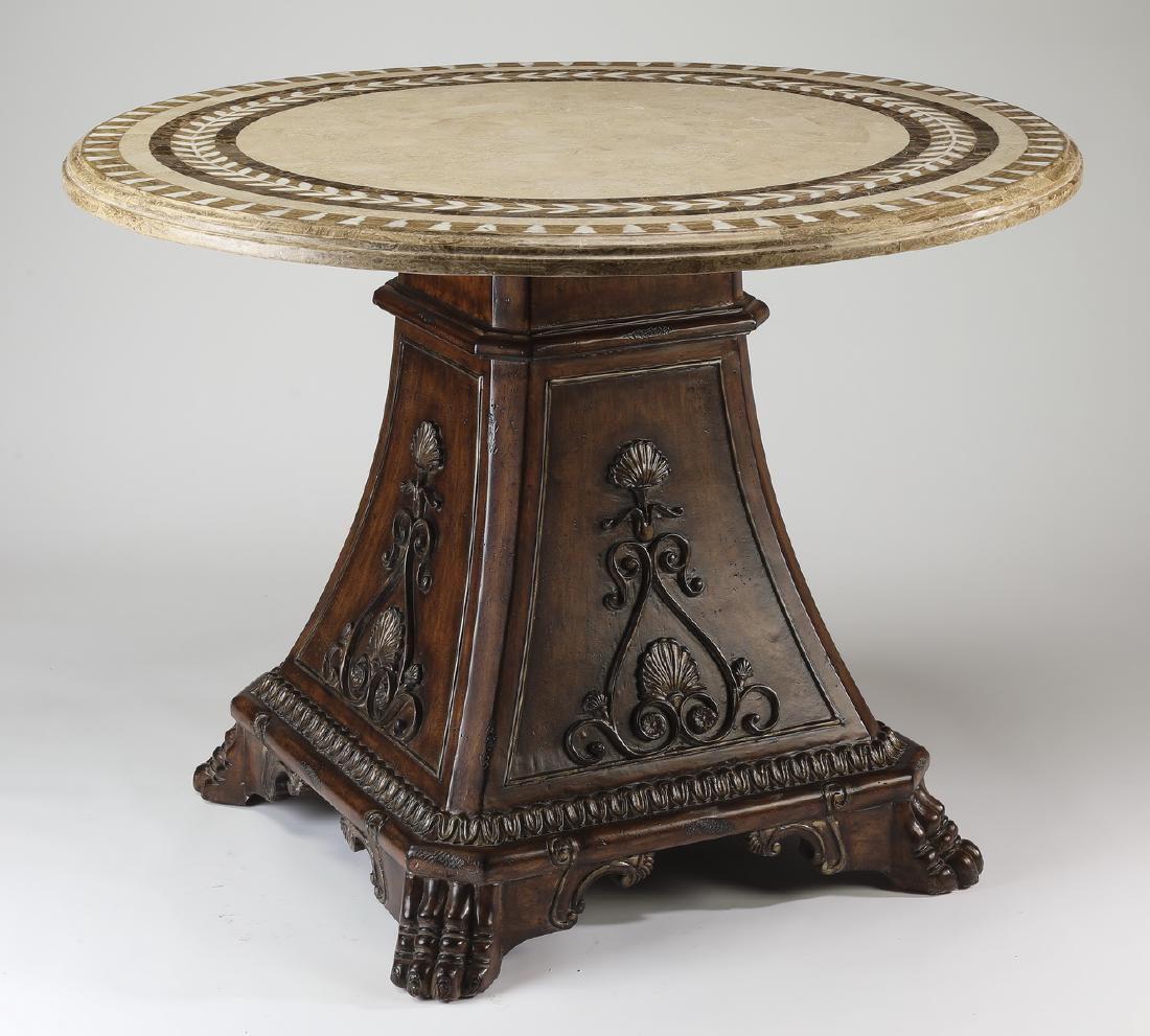 Carved center table with inlaid marble top: French inspired center table, having a circular inlaid marble top accented with geometric motifs, above a mahogany standard with relief carved shells and scrollwork, resting on a gadrooned plinth, and