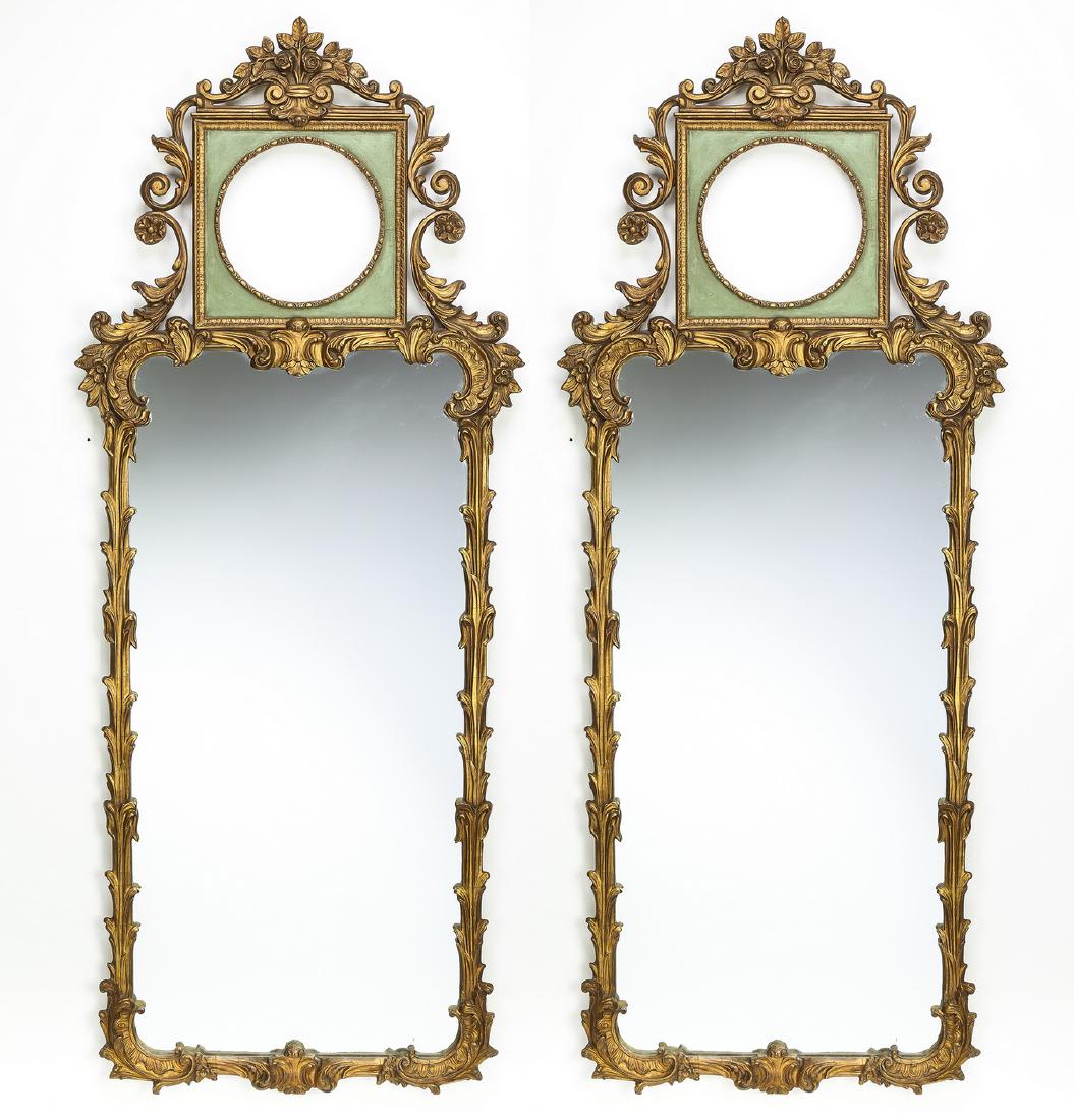 (2) Rococo Revival style paint decorated mirrors: Pair of Rococo Revival style paint decorated wood mirrors, early 20th century, each have a carved rose bouquet crest above a square celadon tablet centering a circular frame flanked by carved 'S' scro