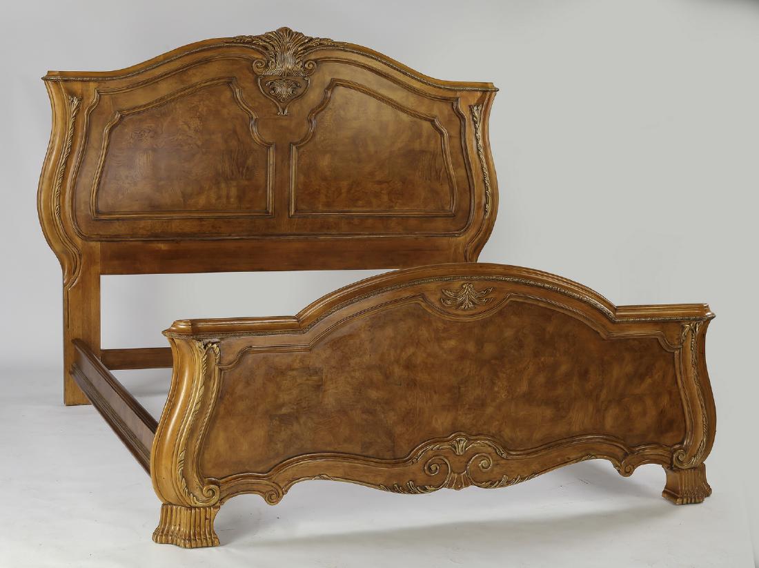 Bernhardt parcel gilt burl wood king size bed: Bernhardt parcel gilt burl wood king size bedstead, having a curving crest centering a carved parcel gilt cartouche above two shaped burl veneered panels, framed by serpentine stiles, leading to strai