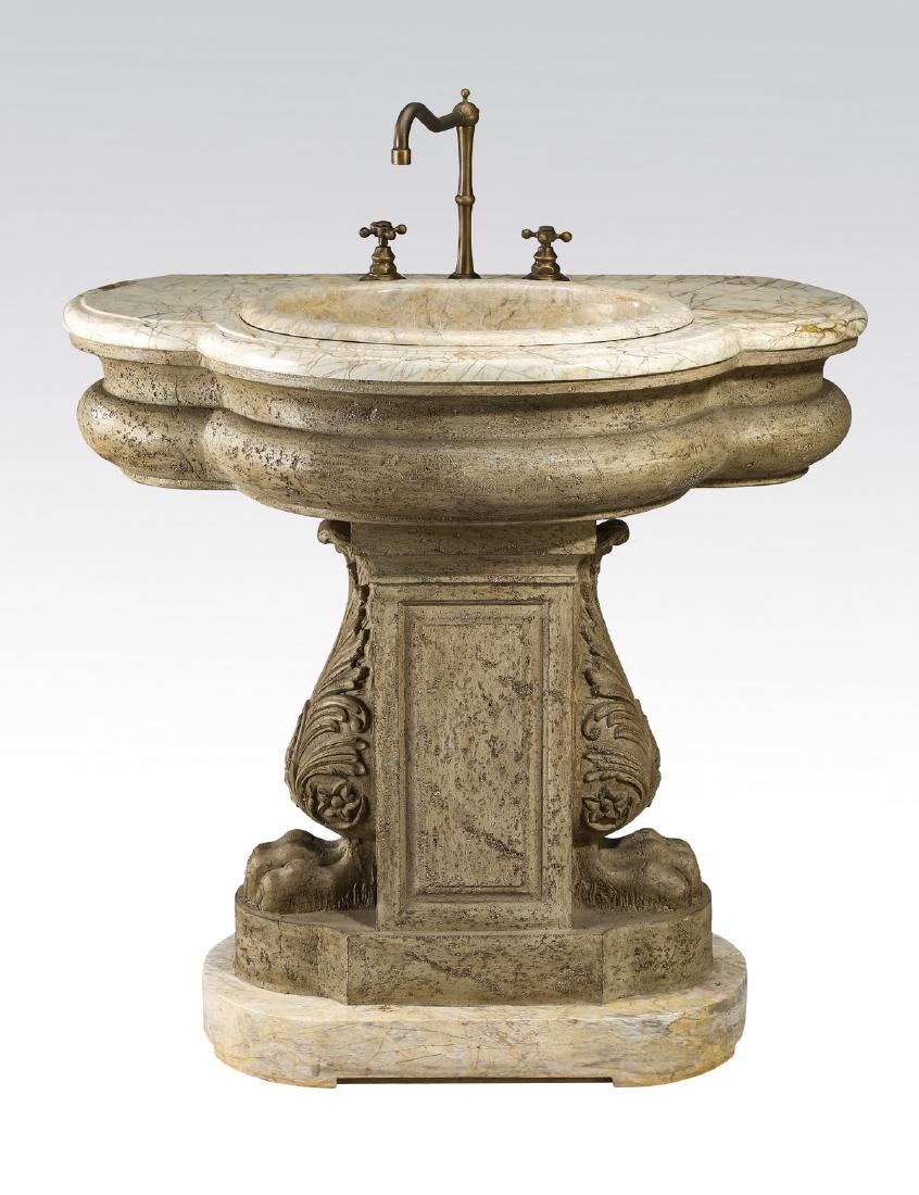 Maitland-Smith Neoclassical marble pedestal sink: Maitland-Smith marble pedestal sink in the Neoclassical taste, having a triple lobed marble top with patinated bronze tone fixtures, over a rectangular composite base flanked by large acanthus leaves,