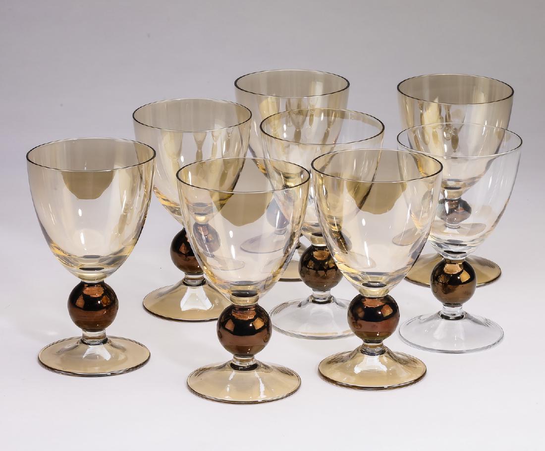 Set of (8) Art Nouveau style amber water glasses: Set of (8) Art Nouveau style water glasses executed in amber glass, each having a dome shaped bowl over a smokey brown knop terminating to a circular foot, 6"h x 3.5"d.