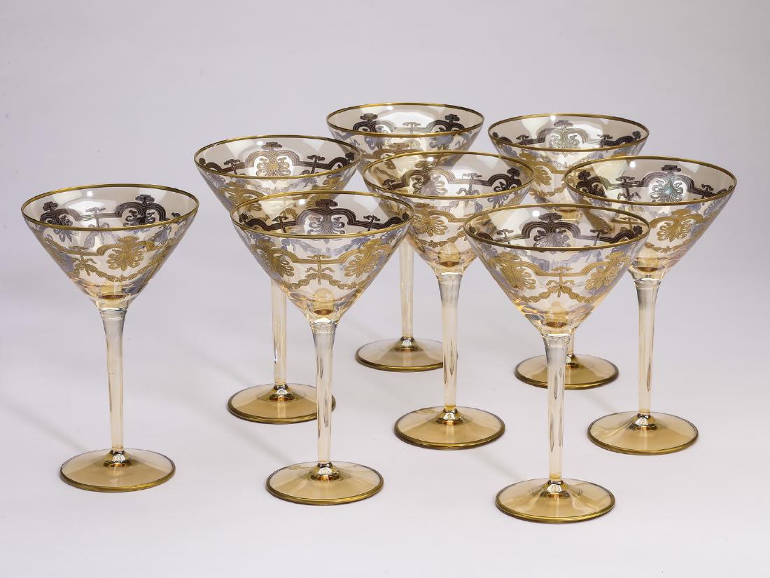 (8) Gilt decorated crystal martini glasses: Set of (8) crystal martini glasses, each having a gilt rim with anthemia and swags below, rising on a cylindrical stem ending in a circular foot, 7"h x 4.5"d.