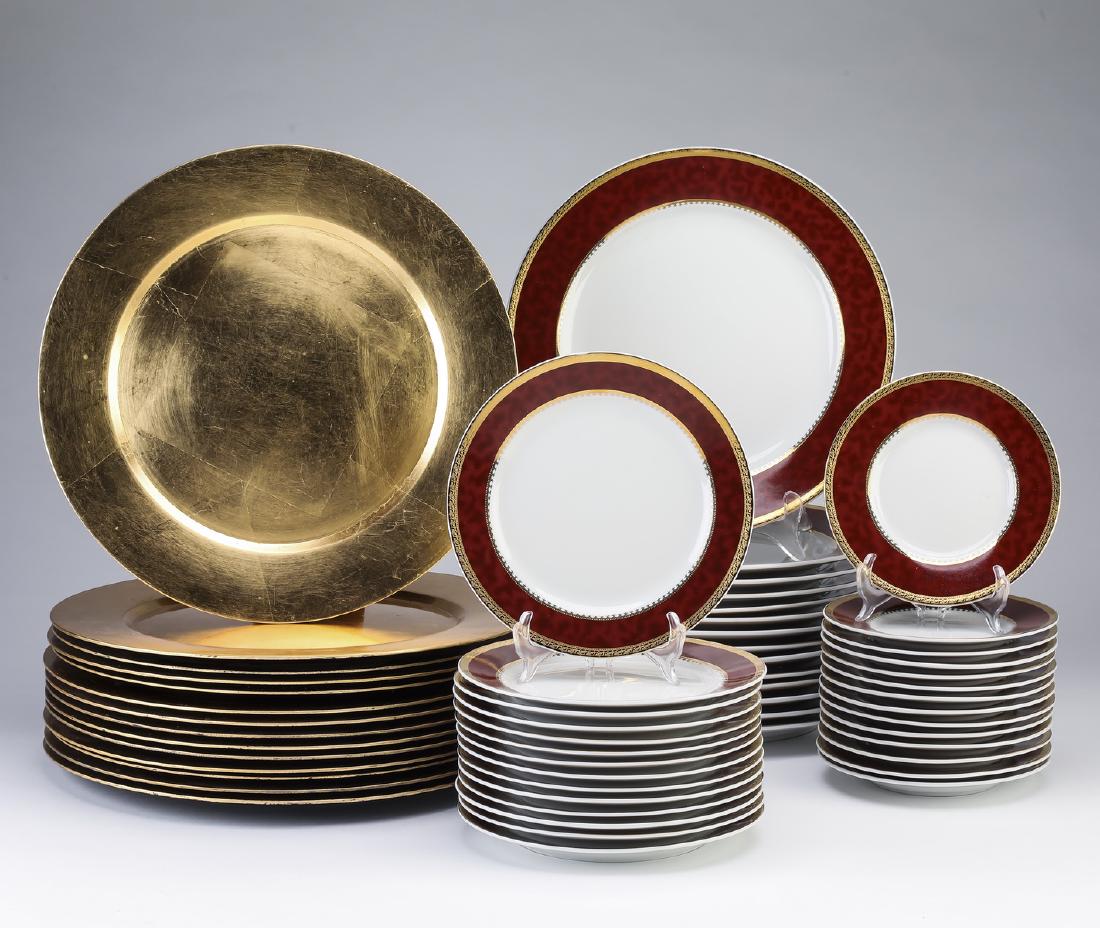 Brilliant Tableware dinner service plus chargers: Brilliant Tableware dinner service for 14, having a gilt edge and motled red rim, comprised of: (14) dinner plates 10.75"d; (14) salad plates 7.5"d; and (14) dessert plates 6.25"d, the undersides mark