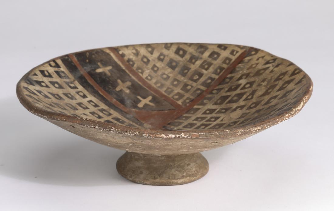 Pre-Columbian polychrome pottery bowl, 7"dia: Pre-Columbian polychrome pottery bowl, Narino peoples of Colombia, circa 850-1500 CE, having a shallow circular dish with a black and red geometric textile pattern on a tan ground, the whole rising on