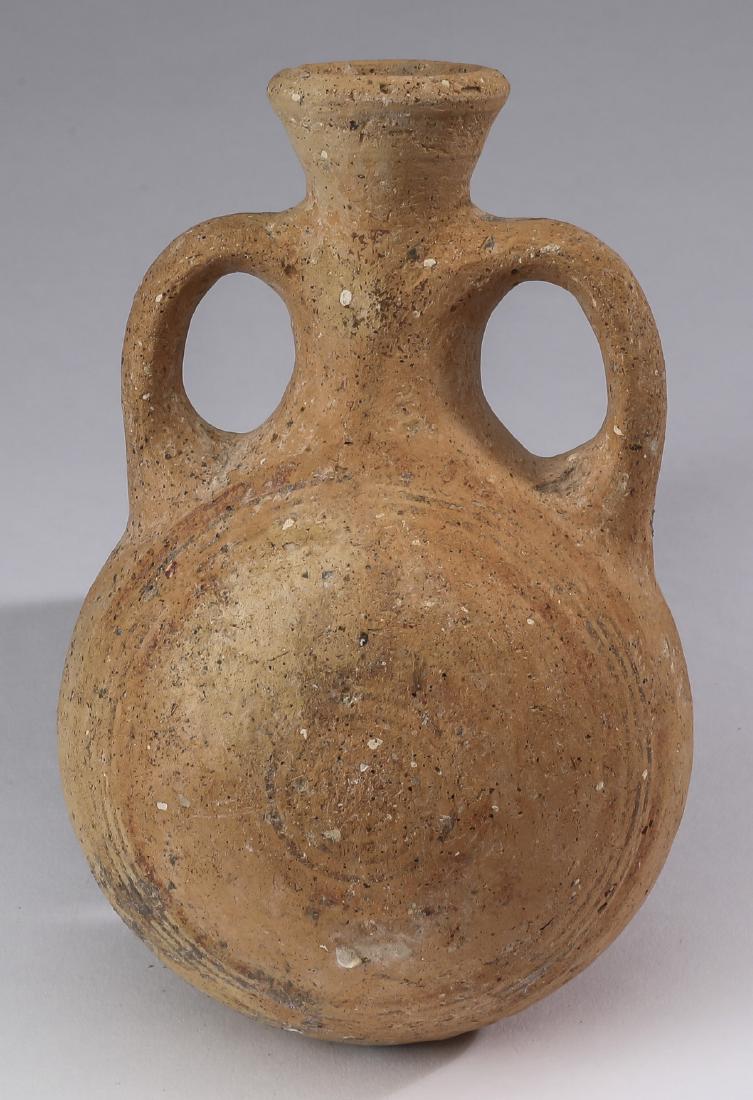 Bronze Age polychrome terracotta pilgrim's flask, 6"h: Bronze Age polychrome terracotta pilgrim's flask, circa 1500 BCE-1250 BCE, having a trumpet neck flanked by loop handles above a moon body retaining vestiges of black and red geometric decoration, 6.2