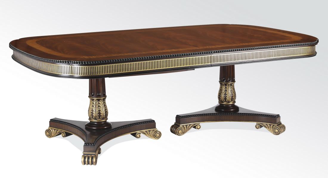 E.J. Victor Regency style dining table w/ leaves: E.J. Victor Regency style mahogany dining table, having a satinwood and kingwood inlaid mahogany surface above the parcel gilt apron resting on two pedestal legs, with fluting and gilt acanthus carvin