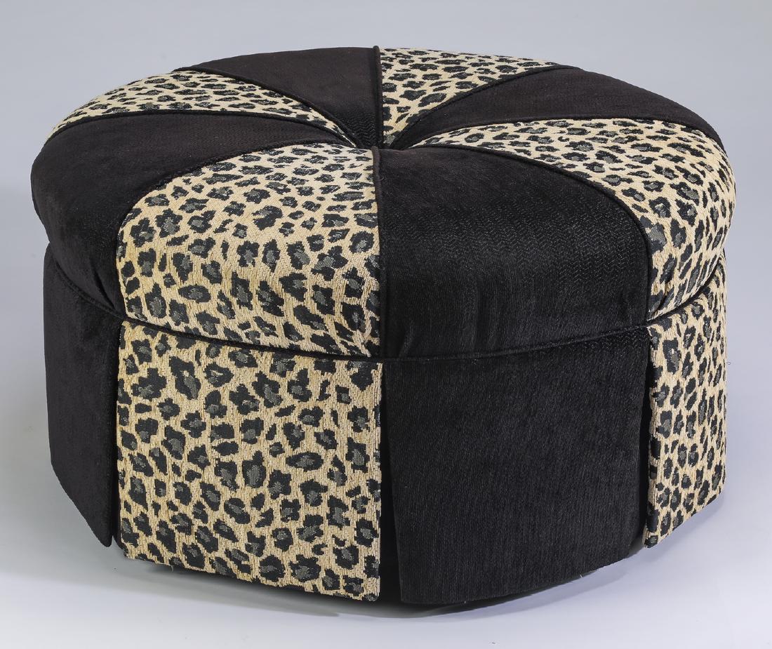 Wesley Hall upholstered ottoman w/ two accent pillows: Wesley Hall upholstered ottoman, covered in a leopard pattern alternating with black herringbone twill fabric, 19"h x 34"d, together with two coordinating accent pillows, 23"w x 23"d .
