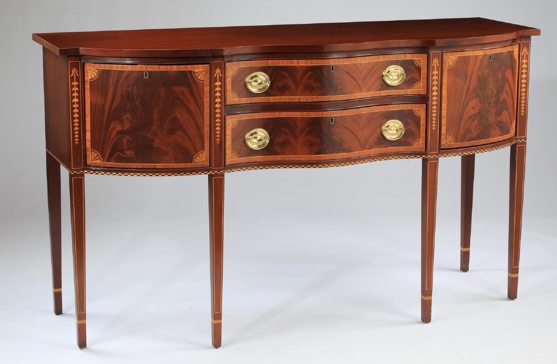 Hepplewhite style marquetry inlaid mahogany sideboard: Hepplewhite style flame mahogany serpentine sideboard by Councill Craftsman, the shaped top surmounting the conforming case centering two drawers flanked by side cabinets interspered with ribbon-tied 
