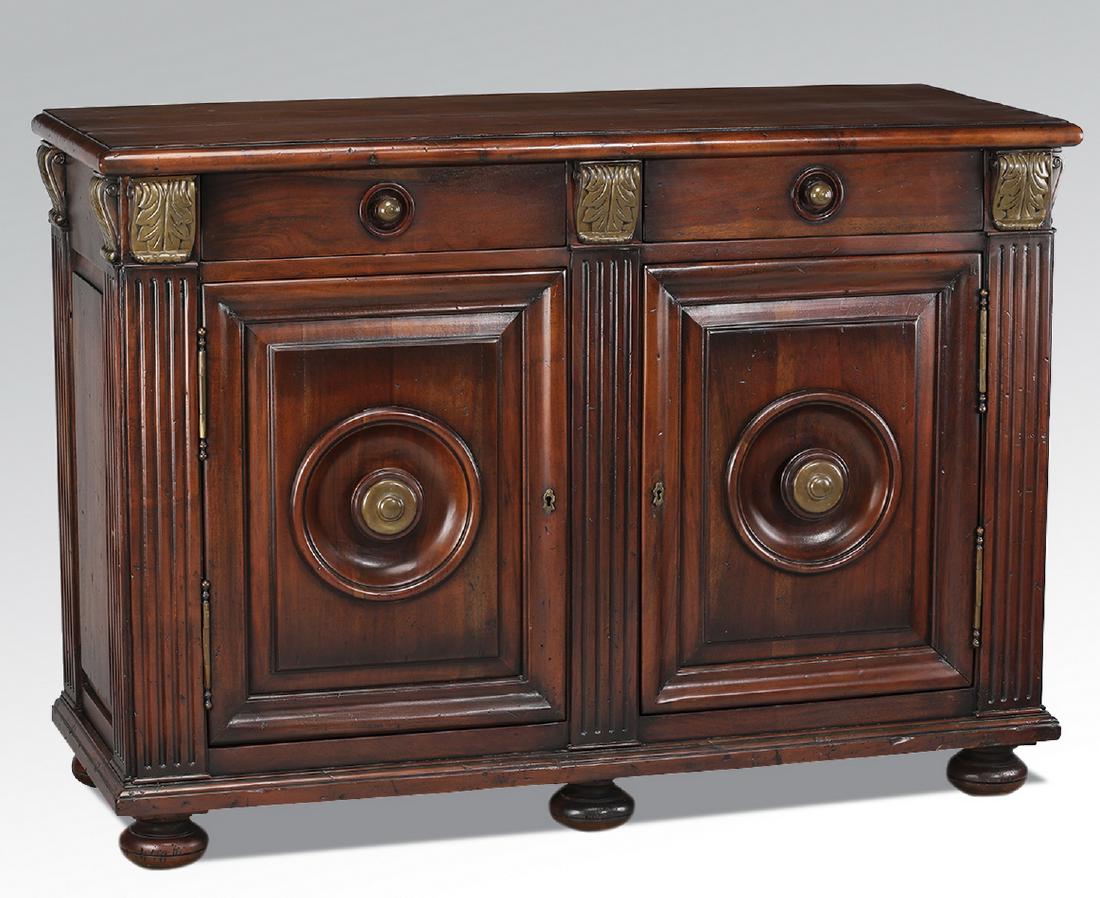 Empire style carved and gilt-decorated commode: Empire style mahogany commode, having two short drawers over two cabinet doors, opening to an inner shelf, all flanked by reeded stiles topped by gilt-decorated acanthus, terminating in six bun feet, 