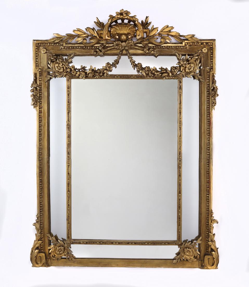 19th c. Continental carved gilt wood mirror, 74"h: Late 19th century Continenal gilt wood Rococo style mirror, having a scallop cartouche flanked by acanthus, above the frame carved with egg and dart borders and draped with garlands, terminating in co
