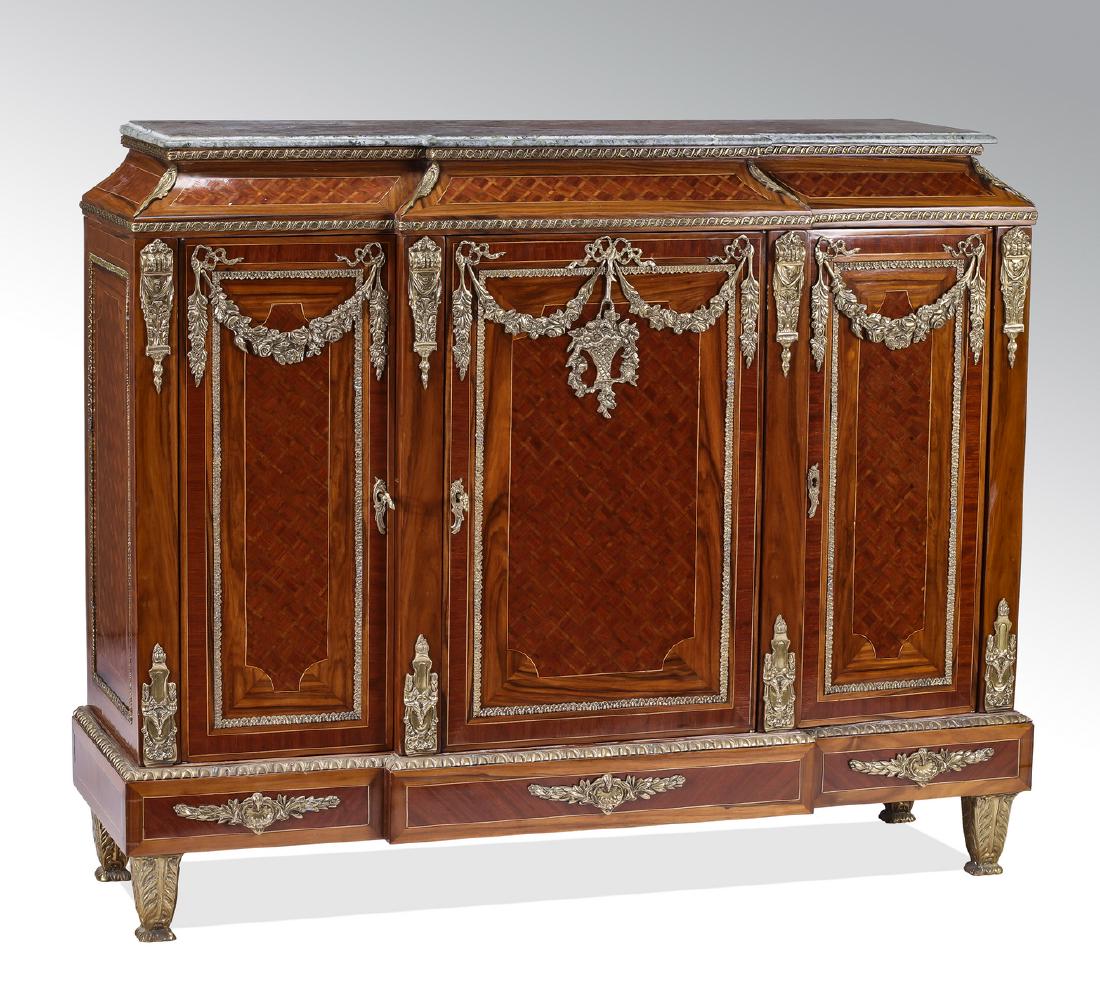 Gilt bronze and parquetry inlaid marble top commode: Gilt bronze and parquetry commode in the Napoleon III taste, executed in mahogany and burl wood, having a rectangular marble top, over an inverted cavetto frieze and conforming cabinet, fitted with th