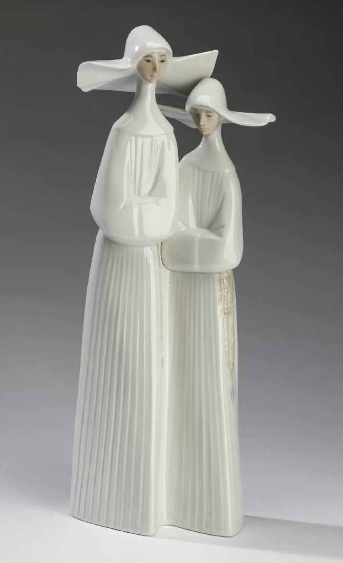 Retired Lladro 'Nuns' porcelain figures, 14"h: Lladro 'Nuns' porcelain figures #4611, designed by Fulgencio Garcia, 1970 and retired in 2017, depicting two nuns wearing the cornette wimple of the brave Daughters of Charity, who wore them to be eas