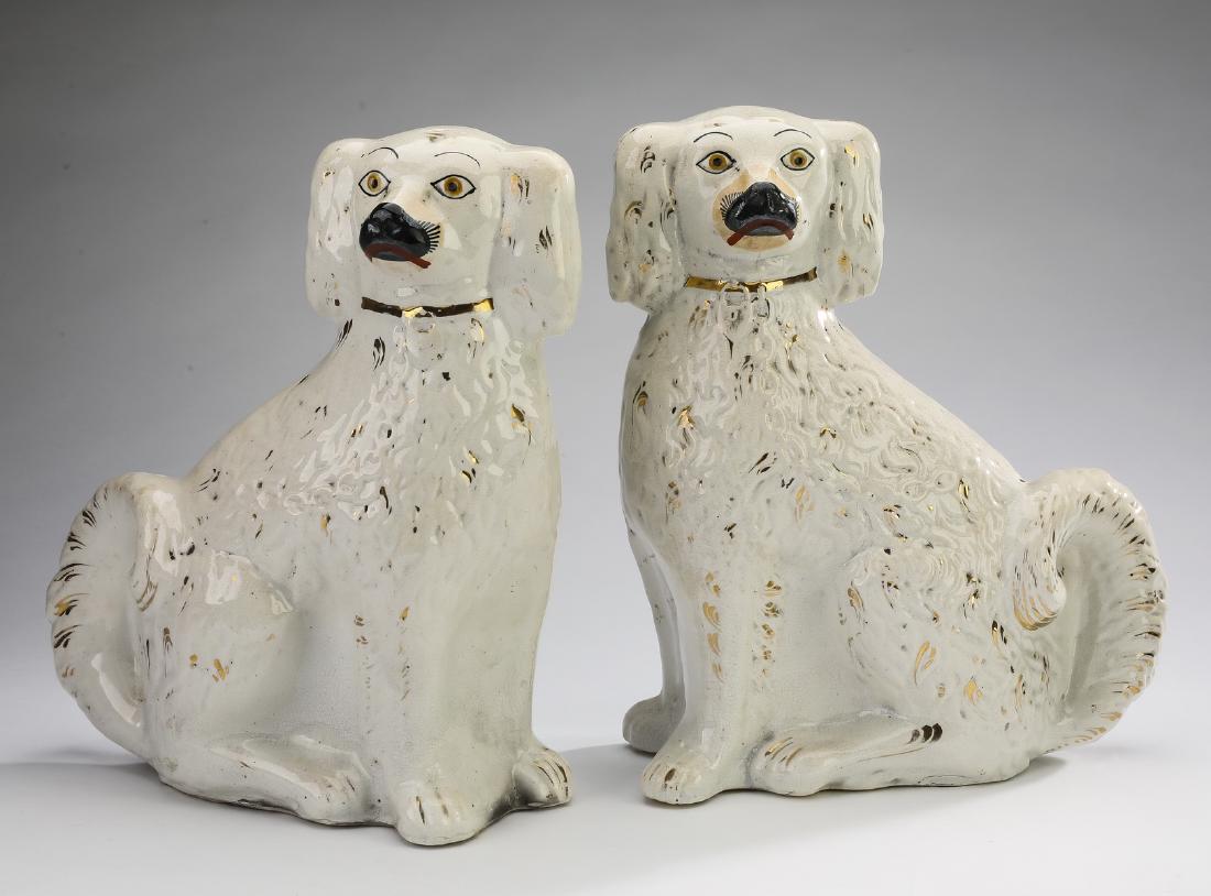 (2) 19th c. English Staffordshire Spaniels, 12"h: Pair of English Staffordshire Spaniels, 19th century, the seated dogs having gilt collars and heart shaped lockets, as well as gilt highlights, 12"h x 10"w x 4.25"d.