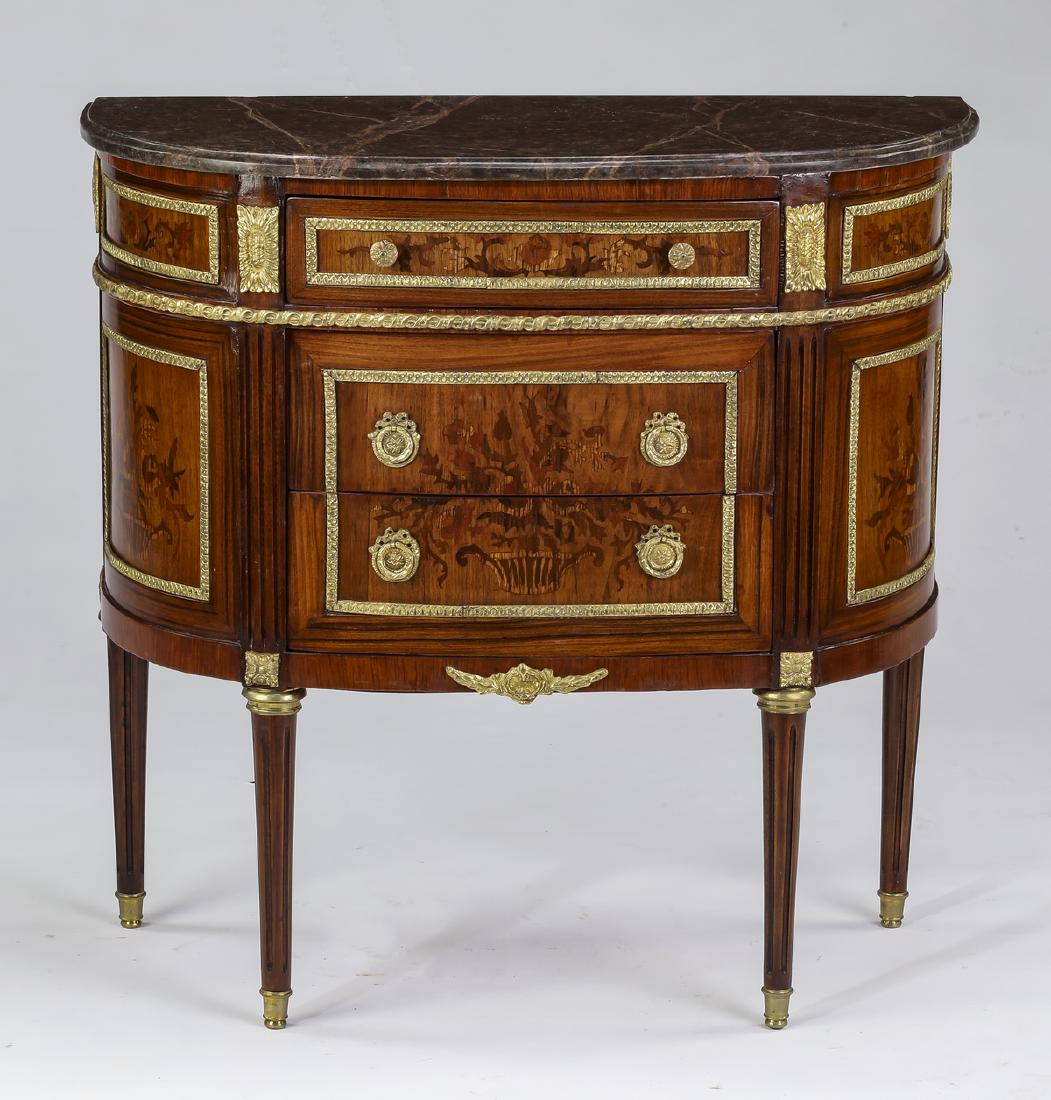 Bronze mounted, marquetry inlaid marble top commode: Marble top demi-lune commode in the Louis XVI taste, the dark plum marble top surmounting a conforming chest with one over two drawers flanked by curved panels, all having polychrome marquetry inlay d