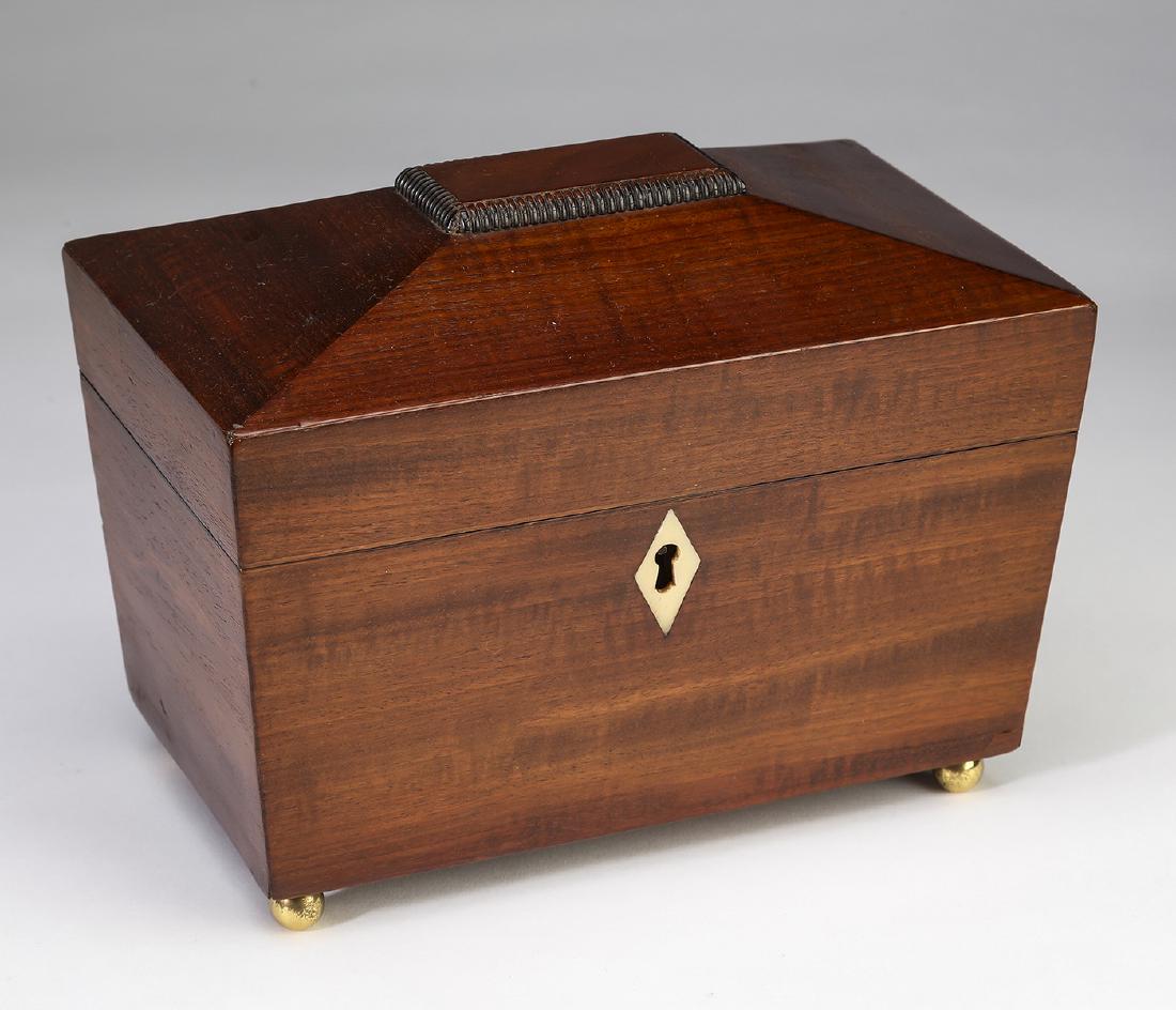 Mahogany Federal period tea caddy: Mahogany Federal period tea caddy, having a coffered top and ivory escutcheon opening to an interior fitted with two compartments each having a lid with an ivory knob, 6"h x 8.5"w x 5"d.